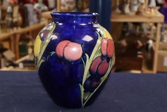 A Moorcroft blue ground Wisteria pattern vase height 22cm